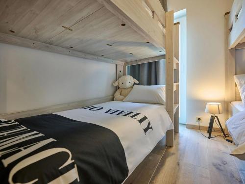 a bedroom with a large bed with a teddy bear on it at Jantjes Tuin in Mall