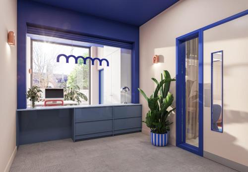 a blue room with a desk with a chair and a window at For Students Only - Central Studios in Reading in Reading