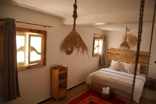 a bedroom with a bed and a window at Grip Sea Morocco in Agadir