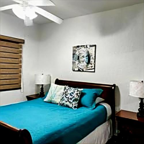 a bedroom with a bed with blue sheets and a ceiling at Ocean Front PRINCESA Resort D108-Sandy Beach-Ground Floor-HUGE in Puerto Peñasco