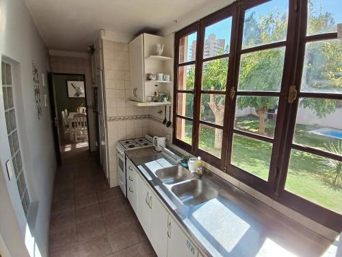 a kitchen with a sink and a large window at Casa Verde 3 in Godoy Cruz