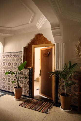 a room with two potted plants and a door at Grip Sea Morocco in Agadir