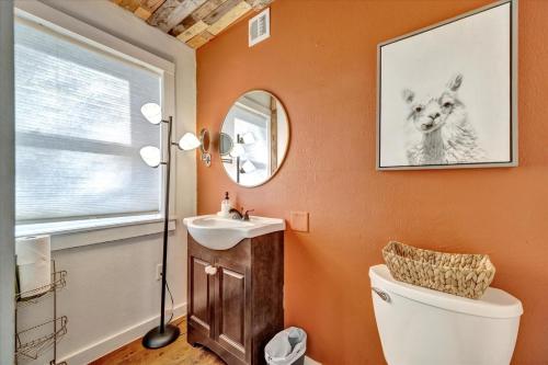 a bathroom with a toilet and a sink and a mirror at Peaceful Studio & Work Friendly Walk to Hyde Park in Tampa