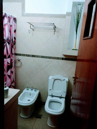 a bathroom with a toilet and a sink at Misky Sonqo in Tilcara