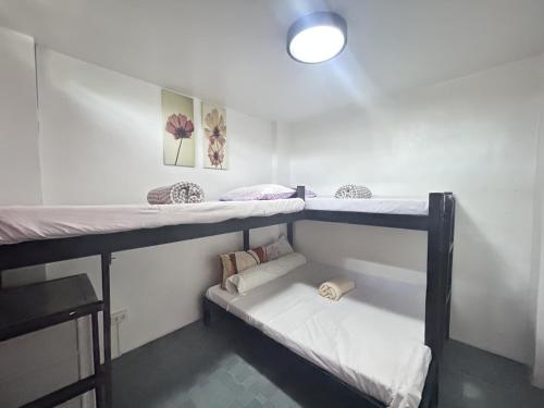 a room with two bunk beds in it at Anabelle Residence in Dumaguete