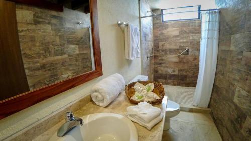 a bathroom with a sink and a toilet and a shower at Casa Sacre in Cuatunalco