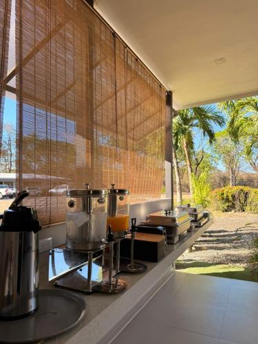 a kitchen with a counter with a large window at Guayacan Real in Nicoya
