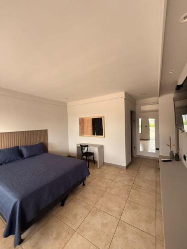 a bedroom with a bed and a table in a room at Guayacan Real in Nicoya