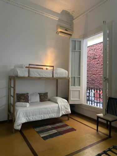 a bedroom with two bunk beds and a window at Lezama Suites in Buenos Aires