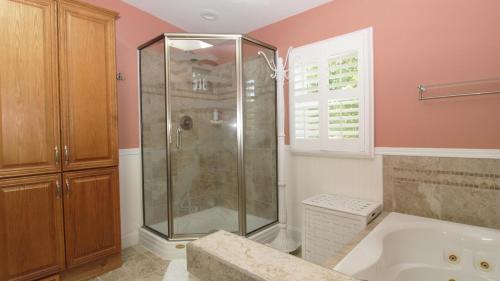 a bathroom with a shower and a tub at Sunset Shore House Second Floor in West Cape May
