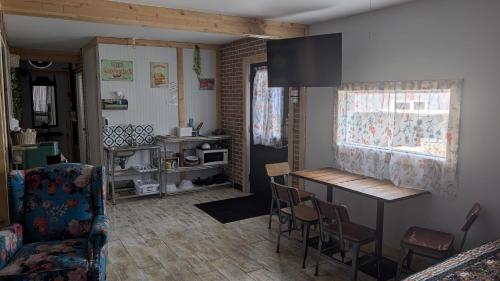 a kitchen with a table and chairs in a room at Geraldton Rooms in Geraldton
