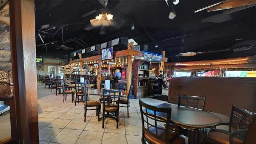 a dining room with tables and chairs in a restaurant at Candlewood Suites Kenedy by IHG in Kenedy
