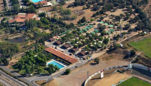 an aerial view of a house with a pool at Hostal - Bungalows Camping Cáceres in Cáceres