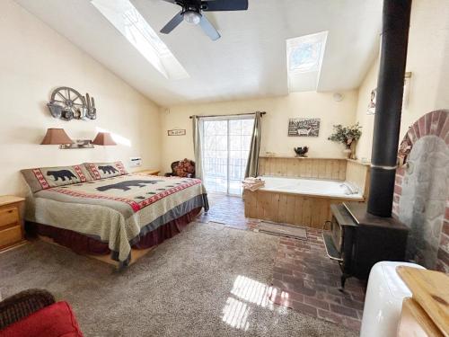 a bedroom with a bed and a bath tub at Pine Knot Guest Ranch in Big Bear Lake