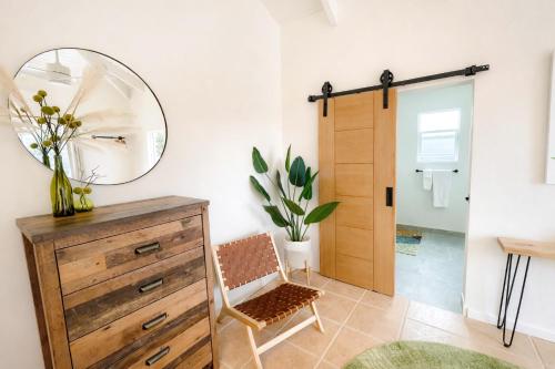 a room with a mirror and a dresser and a chair at Clearview Villas Upper in Island Harbour