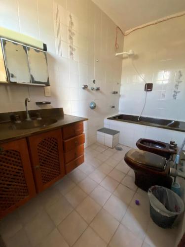 a bathroom with a sink and a toilet in it at Sool Beach Hostel in Bertioga