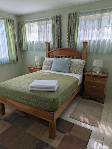 a bedroom with a large bed with a wooden frame at Comsee Apartment Saint Mary in Highgate