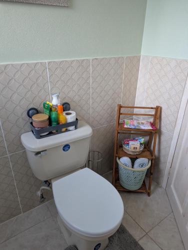 a bathroom with a white toilet in a room at Comsee Apartment Saint Mary in Highgate