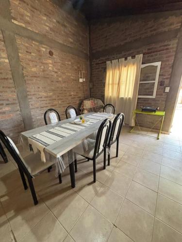 a dining table and chairs in a room at Los Girasoles in Albardón