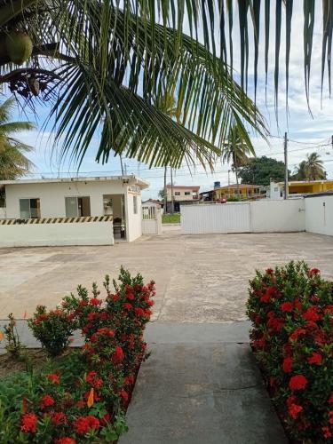 a house with a bunch of flowers in a yard at Pousada Avalon - Lucena - PB in Lucena