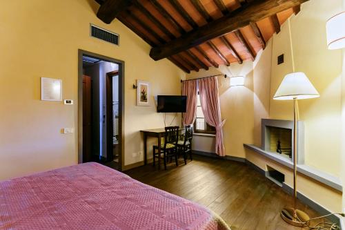 a bedroom with a bed and a table in a room at Le Fonti A San Giorgio in Montespertoli