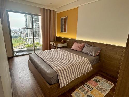 a bedroom with a bed and a large window at 2BR Minato Apartment, Free Swimming Pool & Gym in Hai Phong