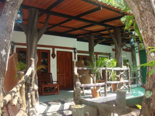 a porch of a house with a wooden roof at The Nature Park Villa in Sigiriya
