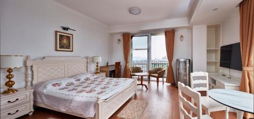a bedroom with a bed and a table and chairs at Luminous Apartments & Suites in Kathmandu
