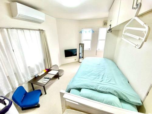 a hospital room with a bed and a table and chairs at トリトン茶屋町#101#102 in Aomori