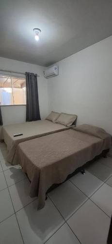 a bedroom with a large bed in a room at Casa 3 quartos - mês com ofertas in Campo Grande