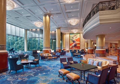 a lobby of a hotel with tables and chairs at Makati Shangri-La, Manila in Manila