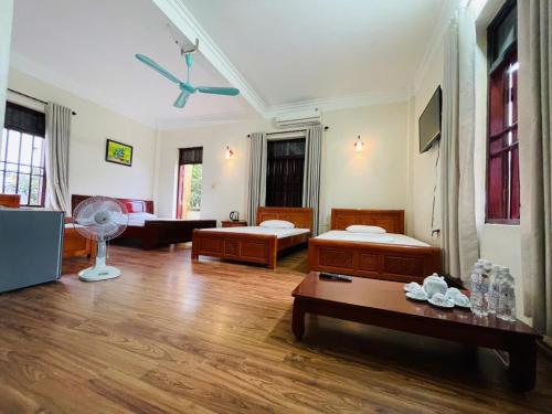 a living room with two beds and a table at Homestay Xuandung in Ninh Binh