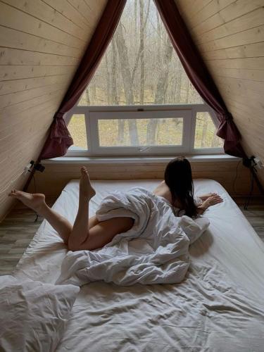 a woman laying on a bed in a tent at Royal rum in Disah