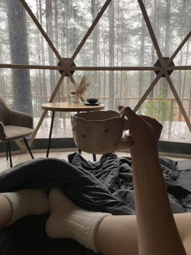 a person laying in bed with a bowl on their head at Royal rum in Disah