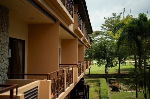 a building with a view of a golf course at Rayong Royal Residence in Ban Chang