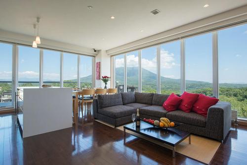 a living room with a couch and a table at Snow Crystal in Kutchan