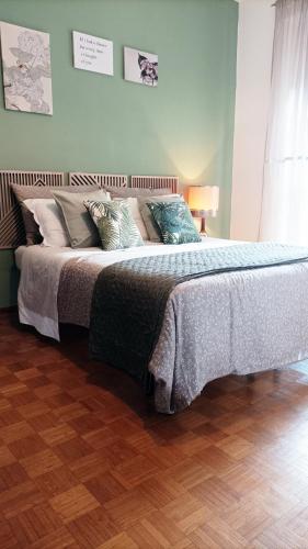 a bedroom with a large bed with pillows on it at QuickHome Appartamento Rovere in Biella