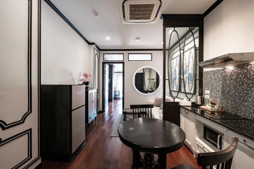 a kitchen and living room with a table and a counter at BAAN 125 STAY Phuket in Phuket
