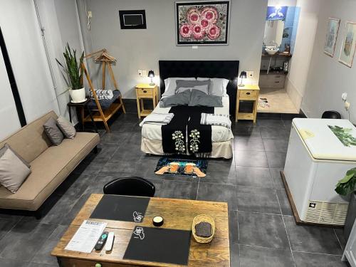 a room with a bed and a couch and a table at Quincho cervecero in San Fernando del Valle de Catamarca