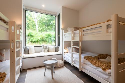 a kids room with bunk beds and a window at Song Saa Chalet in Niseko