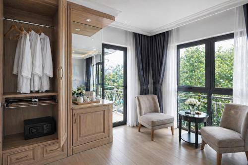 a dressing room with a mirror and two chairs and a table at Evermist Resort DaLat in Da Lat