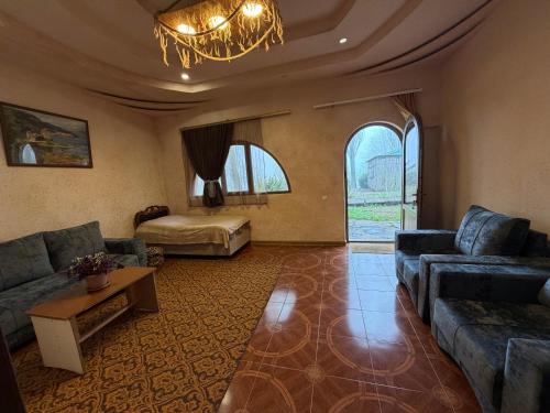 a living room with a couch and a table at Saro B&B in Tatev in Tandzatapʼ