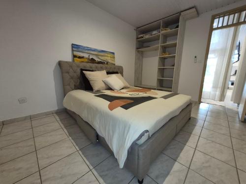 a bedroom with a large bed in a room at Oya - Destination Guyane in Macouria