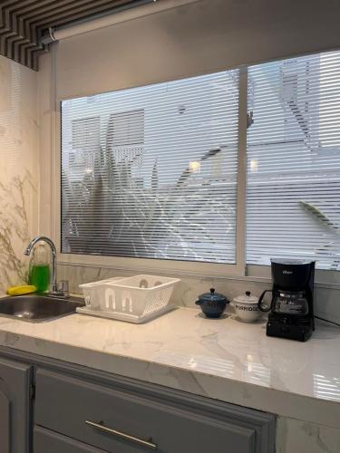 a kitchen counter with a sink and a window at Apartamento Centro Histórico Cartagena in Cartagena de Indias