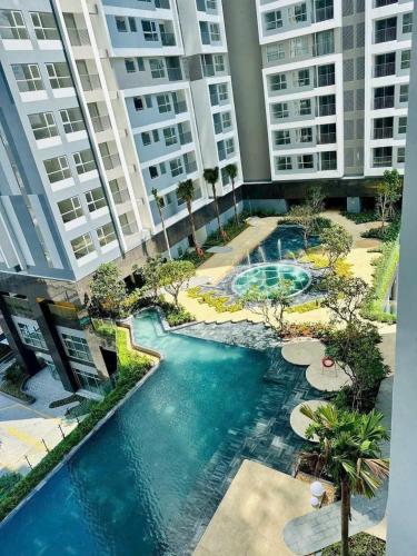 a pool in the middle of a building with tall buildings at JiL JiL homestay in Trạm Chánh An