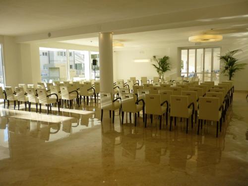 a large room with a bunch of tables and chairs at Hotel Terme Marine Leopoldo II TERME & SPA in Marina di Grosseto
