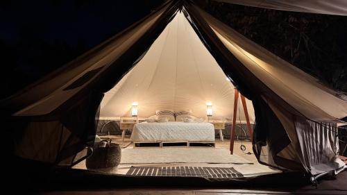 a tent with a bed in the middle of it at Cabinas El Mango in Bribri