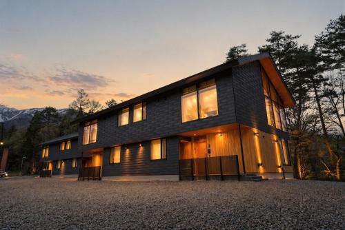 a house with windows on the side of it at Hakuba Amber Echoland MrT by Jade Villa in Hakuba