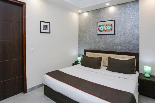 a bedroom with a large bed in a room at Hotel O The Signature inn in Indirapuram