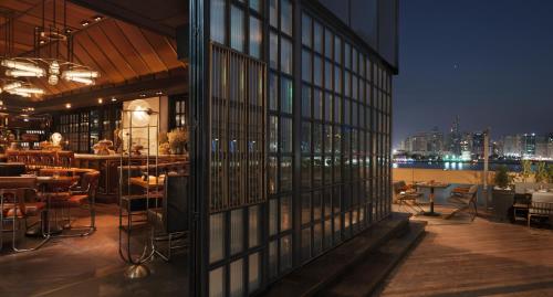 a restaurant with a view of the city at night at Four Seasons Hotel Abu Dhabi at Al Maryah Island in Abu Dhabi